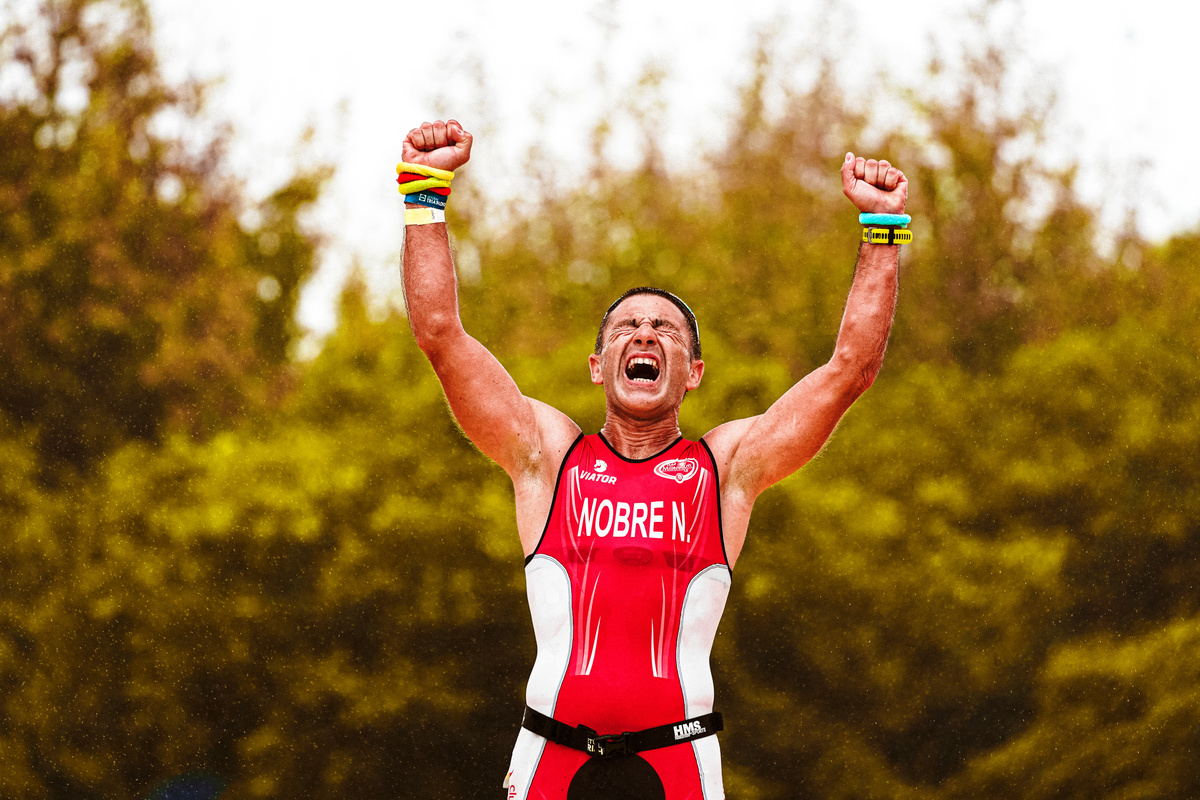 Man in Red and White Shirt Raising Arms